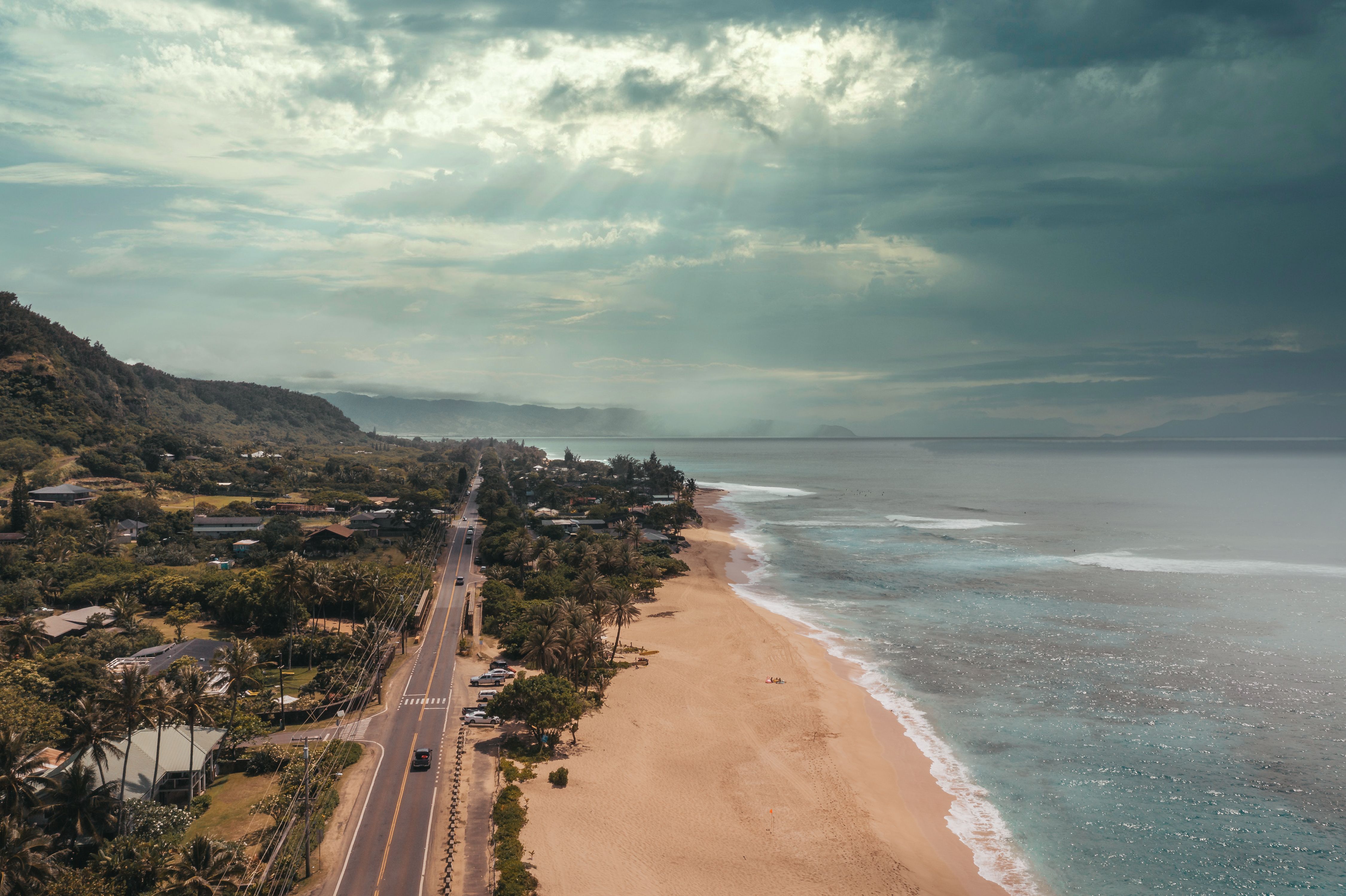 A real aerial photograph of a coastal neighborhood and road on Oʻahu’s North Shore by Jess Loiterton