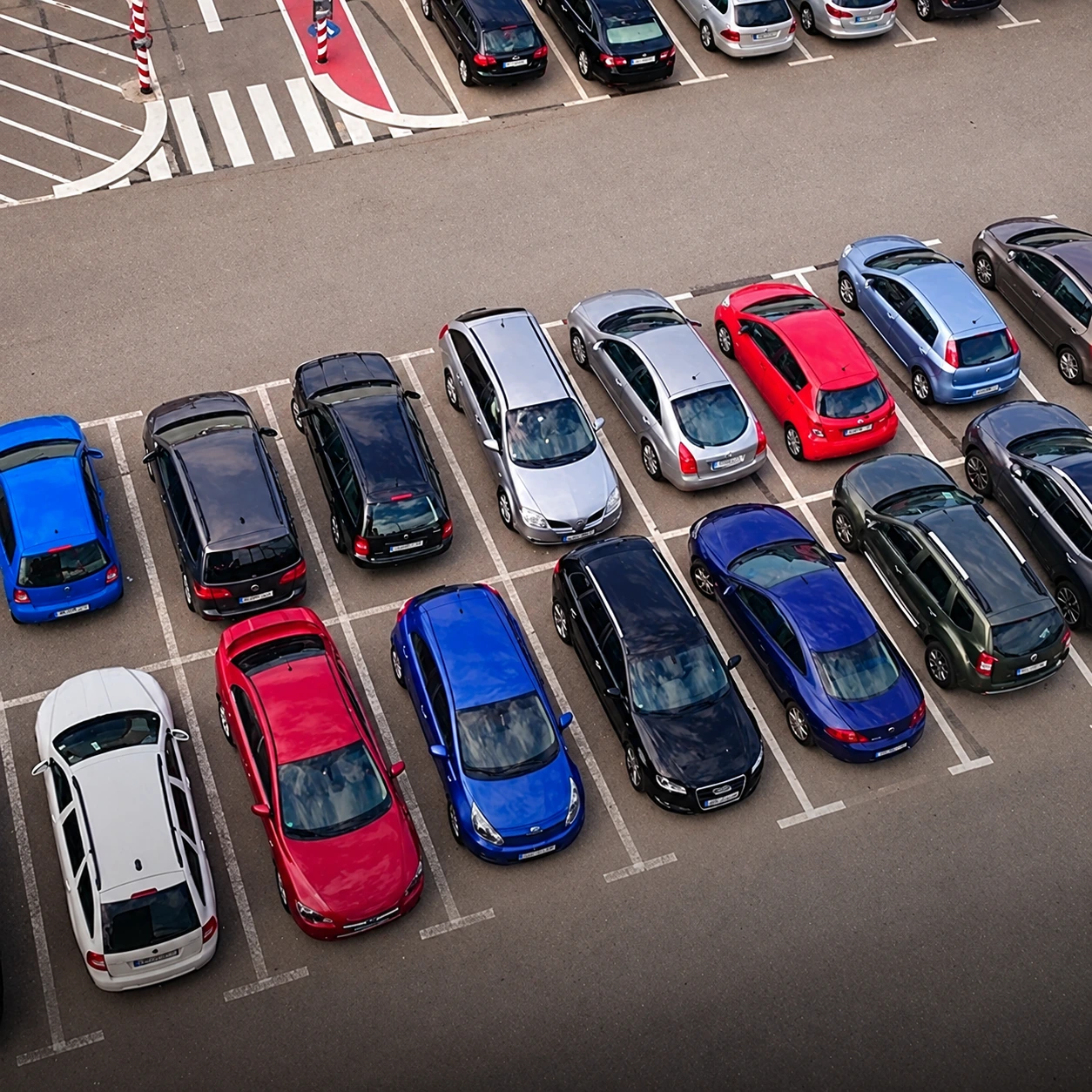 An overhead view of vehicles in a private parking lot